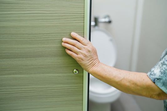Older adult opening a bathroom door
