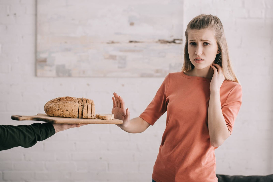 Woman putting hand up to reject bread
