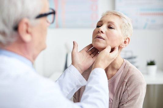 Doctor's Exam of Woman's Thyroid