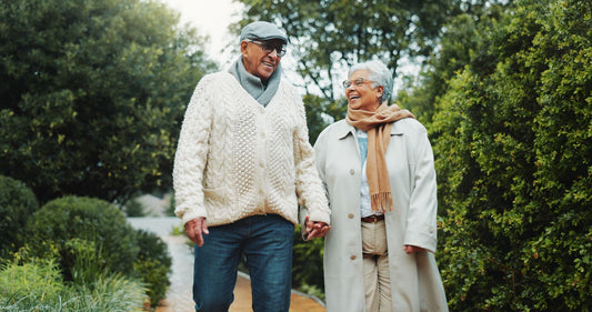 Older Couple Walking Hand in Hand Outdoors