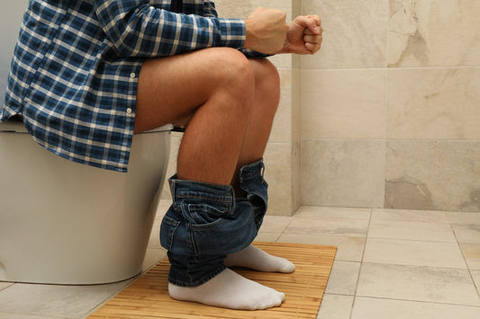 Person sitting on toilet