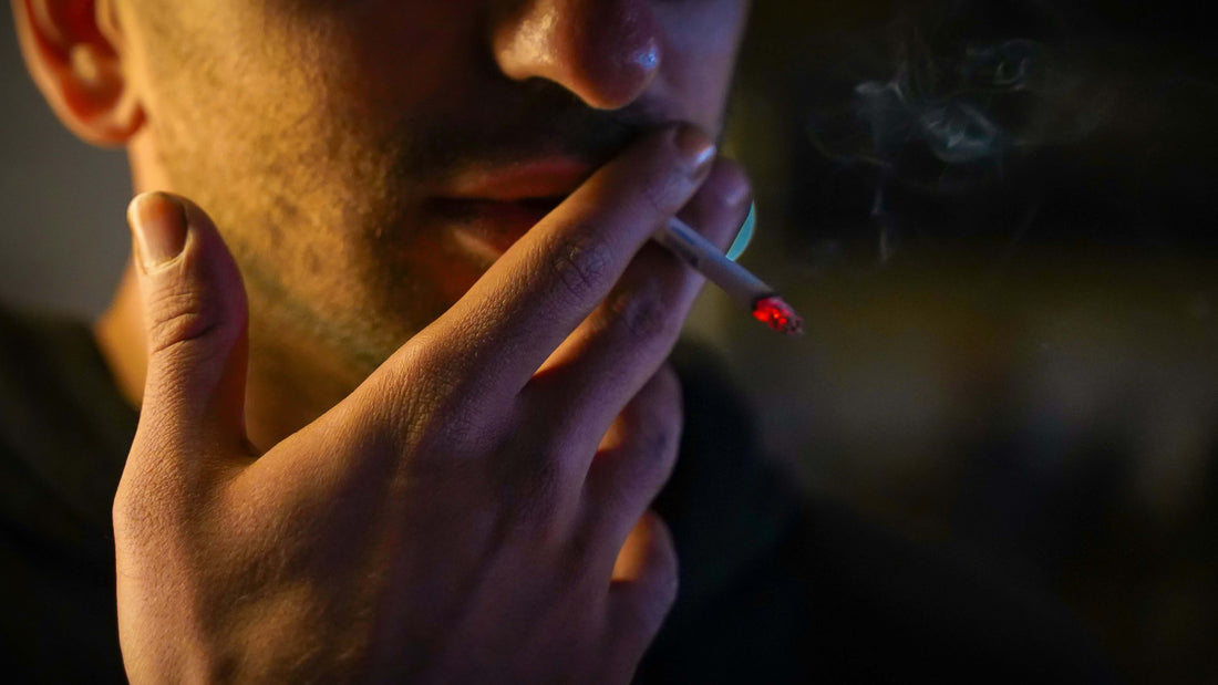 Man smoking a cigarette with his face partially obscured