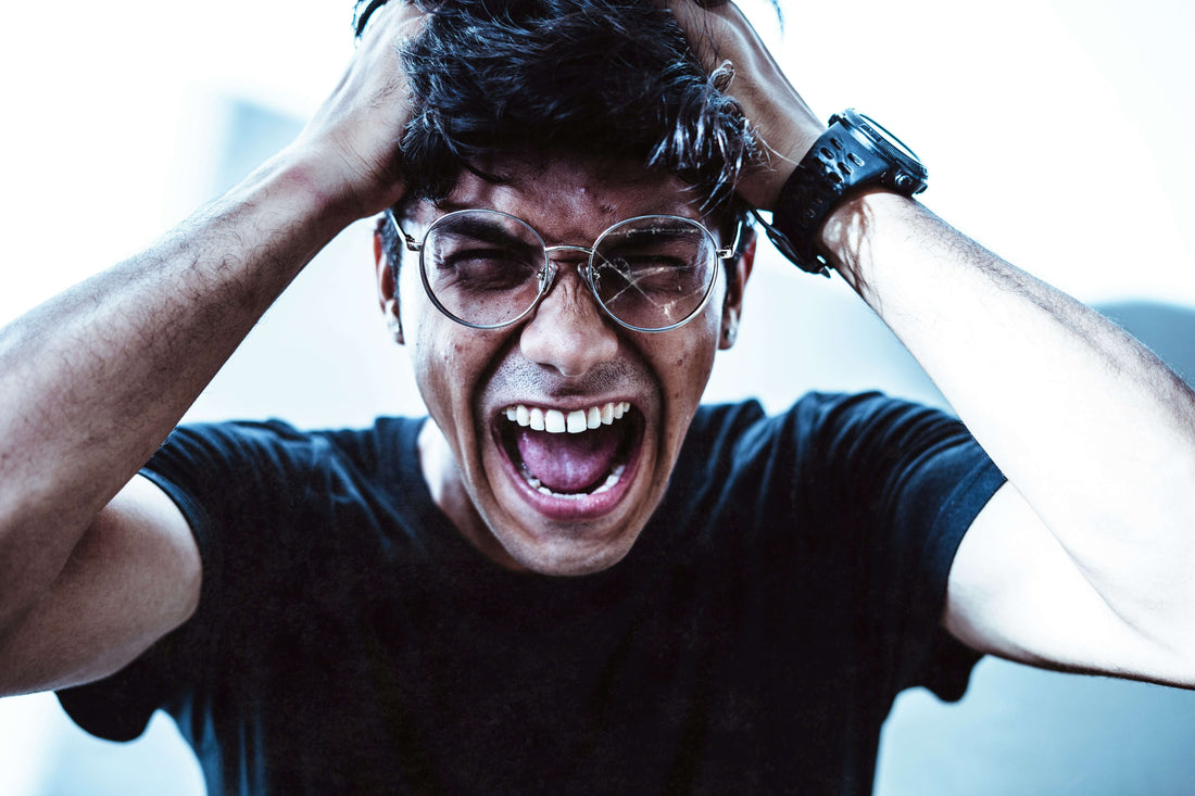 Stressed man with hands on the side of his head