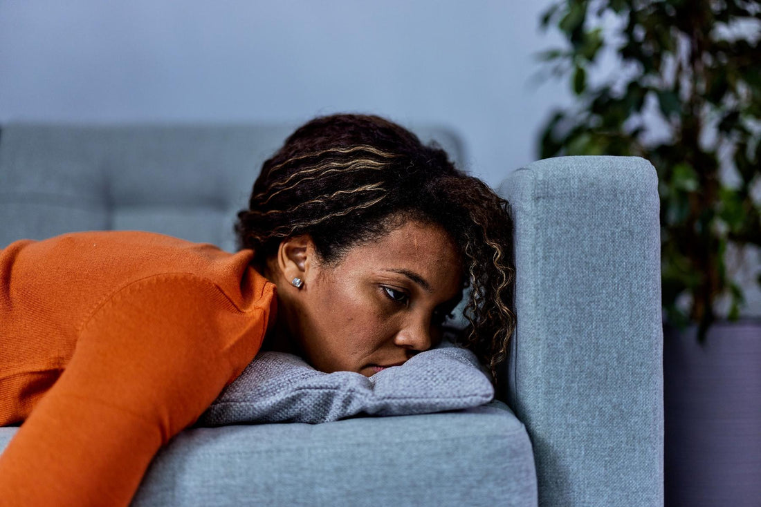 Tired Woman Resting on a Sofa at Home