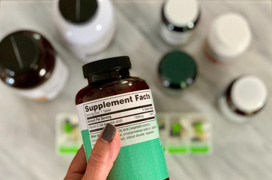Person Holding Supplement Bottle