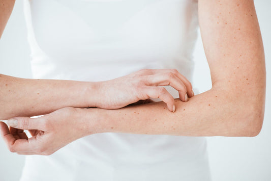 Woman with zinc deficiency scratching the skin on her forearm