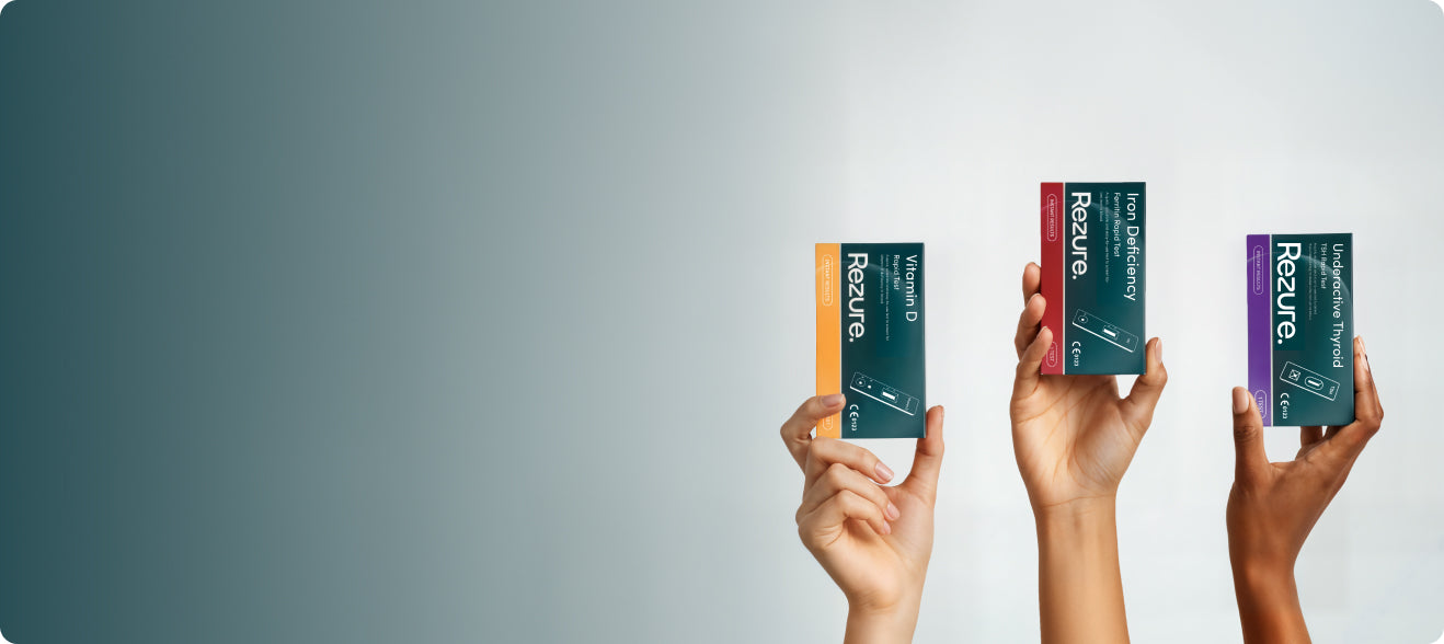 Three boxes of Rezure tests held by hands against a gray background