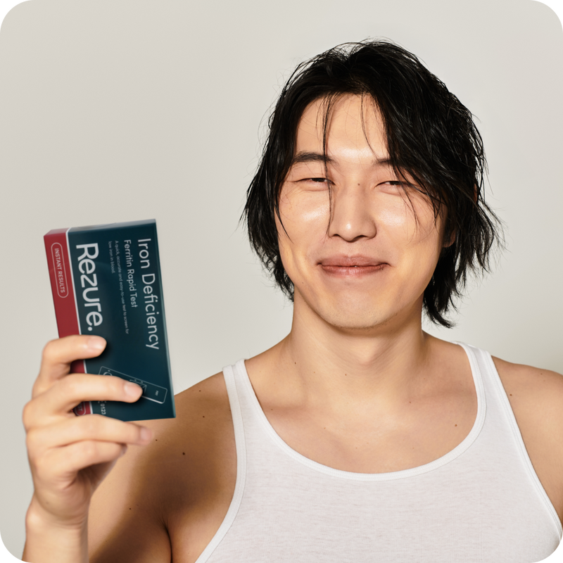 Person holding a Rezure Iron Test with a plain background