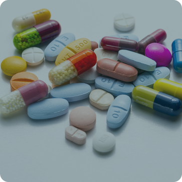 Assorted colorful pills and capsules on a white background